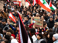 Protesters attend a demonstration in support of Lebanese people as intense Israeli attacks across Lebanon's east, south, and southern Beirut...