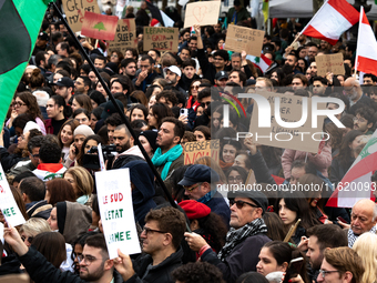 A protester holds a sign reading "stop killing the Lebanese people" during a demonstration in support of Lebanese people as intense Israeli...