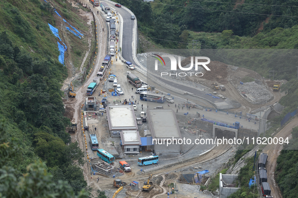 Stranded vehicles are pictured from Jhyaple Khola in Dhading District of Central Nepal after a landslide disrupts vehicular movement along t...