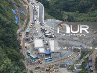 Stranded vehicles are pictured from Jhyaple Khola in Dhading District of Central Nepal after a landslide disrupts vehicular movement along t...