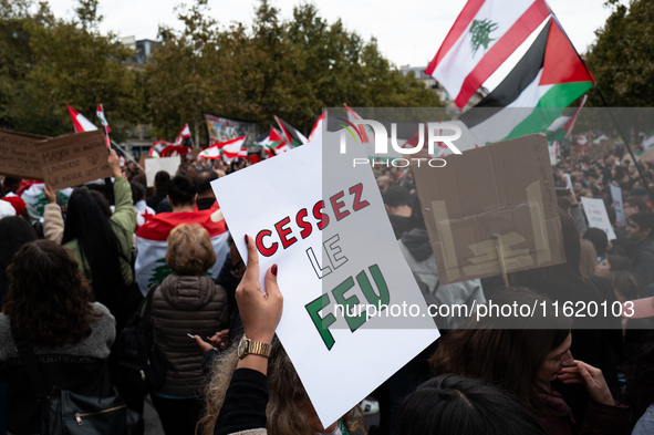 A protester holds a sign reading "Cease fire" during a demonstration in support of Lebanese people as intense Israeli attacks across Lebanon...