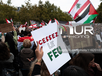 A protester holds a sign reading "Cease fire" during a demonstration in support of Lebanese people as intense Israeli attacks across Lebanon...