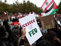 A protester holds a sign reading "Cease fire" during a demonstration in support of Lebanese people as intense Israeli attacks across Lebanon...