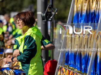 Volunteers organize medals to welcome the finishers of the Berlin Marathon in Berlin, Germany, on September 29, 2024. The 50th Berlin Marath...