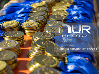 Volunteers organize medals to welcome the finishers of the Berlin Marathon in Berlin, Germany, on September 29, 2024. The 50th Berlin Marath...