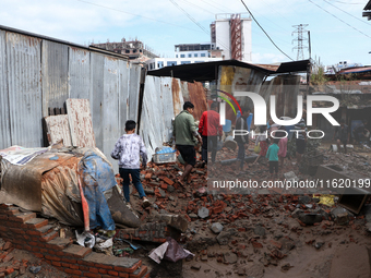 A section of walkways in Imadol, Lalitpur, Nepal, caves in after torrential rainfall and waterlogging on September 29, 2024. Nepal witnesses...