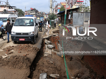 A section of walkways in Imadol, Lalitpur, Nepal, caves in after torrential rainfall and waterlogging on September 29, 2024. Nepal witnesses...