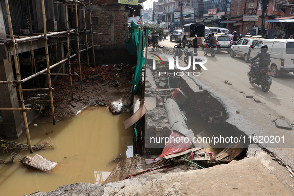 A section of walkways in Imadol, Lalitpur, Nepal, caves in after torrential rainfall and waterlogging on September 29, 2024. Nepal witnesses...