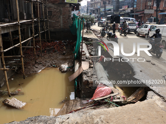 A section of walkways in Imadol, Lalitpur, Nepal, caves in after torrential rainfall and waterlogging on September 29, 2024. Nepal witnesses...