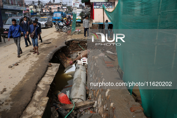 A section of walkways in Imadol, Lalitpur, Nepal, caves in after torrential rainfall and waterlogging on September 29, 2024. Nepal witnesses...