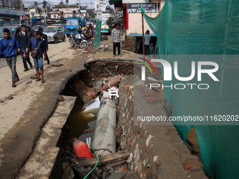 A section of walkways in Imadol, Lalitpur, Nepal, caves in after torrential rainfall and waterlogging on September 29, 2024. Nepal witnesses...