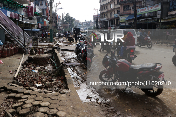 A section of walkways in Imadol, Lalitpur, Nepal, caves in after torrential rainfall and waterlogging on September 29, 2024. Nepal witnesses...