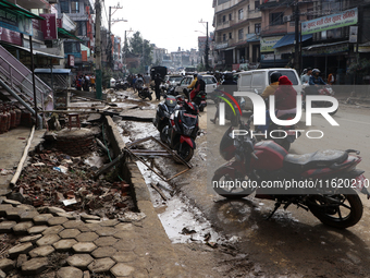 A section of walkways in Imadol, Lalitpur, Nepal, caves in after torrential rainfall and waterlogging on September 29, 2024. Nepal witnesses...