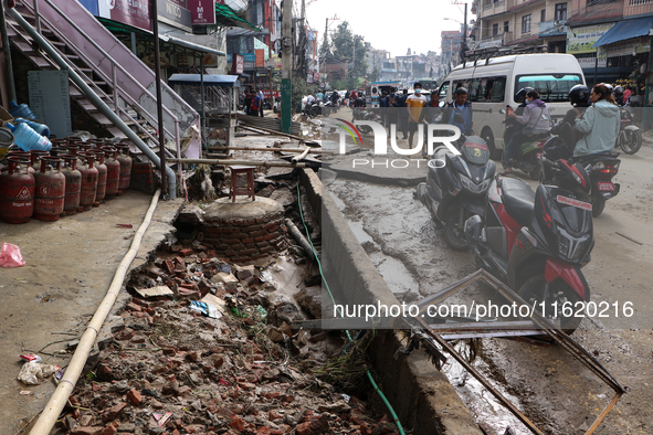 A section of walkways in Imadol, Lalitpur, Nepal, caves in after torrential rainfall and waterlogging on September 29, 2024. Nepal witnesses...