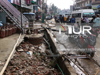 A section of walkways in Imadol, Lalitpur, Nepal, caves in after torrential rainfall and waterlogging on September 29, 2024. Nepal witnesses...