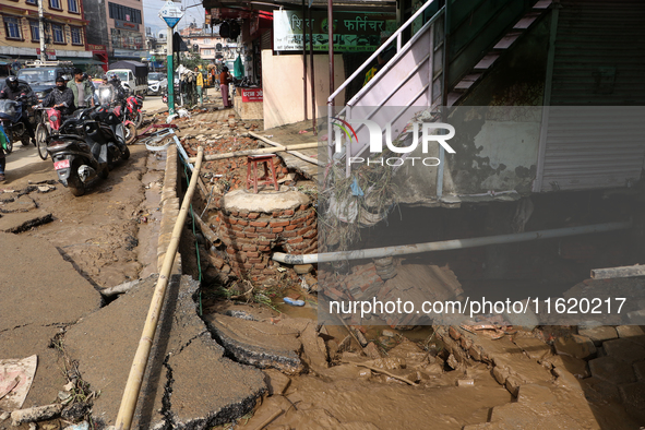 A section of walkways in Imadol, Lalitpur, Nepal, caves in after torrential rainfall and waterlogging on September 29, 2024. Nepal witnesses...