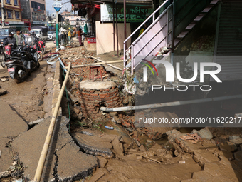 A section of walkways in Imadol, Lalitpur, Nepal, caves in after torrential rainfall and waterlogging on September 29, 2024. Nepal witnesses...