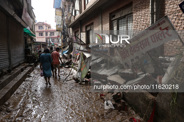 A section of walkways in Imadol, Lalitpur, Nepal, caves in after torrential rainfall and waterlogging on September 29, 2024. Nepal witnesses...