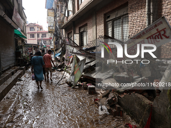 A section of walkways in Imadol, Lalitpur, Nepal, caves in after torrential rainfall and waterlogging on September 29, 2024. Nepal witnesses...