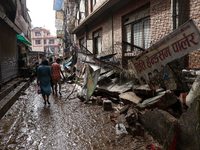 A section of walkways in Imadol, Lalitpur, Nepal, caves in after torrential rainfall and waterlogging on September 29, 2024. Nepal witnesses...