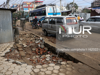 A section of walkways in Imadol, Lalitpur, Nepal, caves in after torrential rainfall and waterlogging on September 29, 2024. Nepal witnesses...