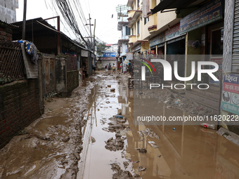 A passenger way in Imadol, Lalitpur, Nepal, on September 29, 2024, is covered in mud after heavy rain triggers waterlogging in the area. Nep...