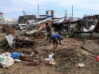 People in Imadol, Lalitpur, Nepal, salvage their damaged properties after heavy rain triggers waterlogging in the area on September 29, 2024...