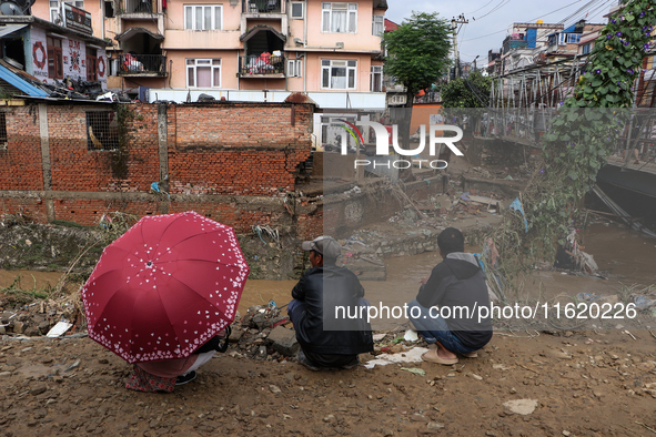 Locals of Imadol, Lalitpur, Nepal, look at their damaged home after heavy rain triggers a flood in local rivers in the area on September 29,...