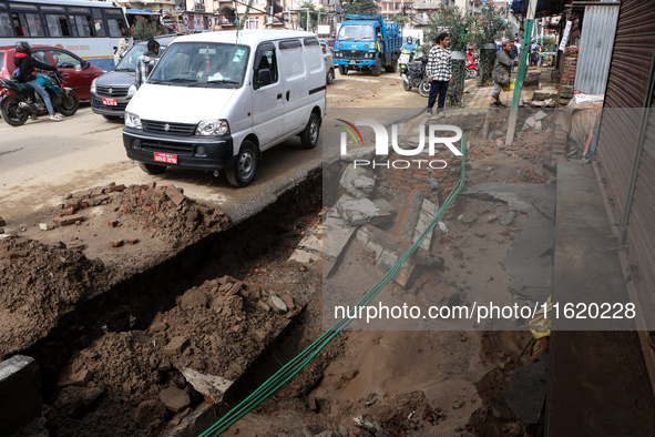 A section of walkways in Imadol, Lalitpur, Nepal, caves in after torrential rainfall and waterlogging on September 29, 2024. Nepal witnesses...