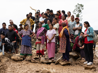 Spectators and relatives watch as the rescue teams conduct search operations at Jhyaple Khola in Dhading District, Nepal, on September 29, 2...