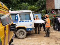 Rescue teams recover the bodies of bus passengers buried in a landslide in Jhyaple Khola, Dhading District, Nepal, on September 29, 2024, af...