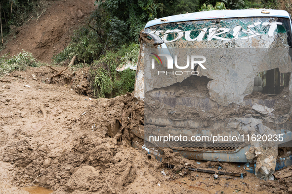 A picture of the buried bus at Jhyaple Khola in Dhading District, Nepal, on September 29, 2024. Heavy rainfall on the 28th triggers landslid...