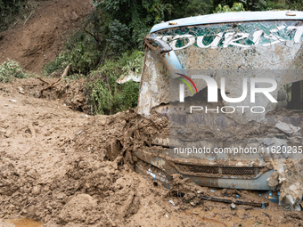 A picture of the buried bus at Jhyaple Khola in Dhading District, Nepal, on September 29, 2024. Heavy rainfall on the 28th triggers landslid...