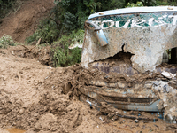 A picture of the buried bus at Jhyaple Khola in Dhading District, Nepal, on September 29, 2024. Heavy rainfall on the 28th triggers landslid...