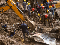 Rescue teams conduct search operations at Jhyaple Khola, Dhading District, Nepal, on September 29, 2024, after passenger buses are buried in...