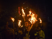 Doctors march with burning torches and shout slogans during a protest against the rape and murder of a PGT woman doctor at Government-run R...