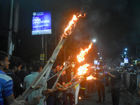 Doctors march with burning torches and shout slogans during a protest against the rape and murder of a PGT woman doctor at Government-run R...