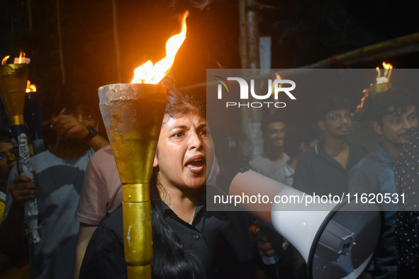 Doctors march with burning torches and shout slogans during a protest against the rape and murder of a PGT woman doctor at Government-run R...