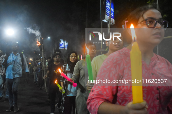 Doctors march with candles during a protest and shout slogans, protesting against the rape and murder of a PGT woman doctor at Government-ru...