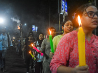 Doctors march with candles during a protest and shout slogans, protesting against the rape and murder of a PGT woman doctor at Government-ru...