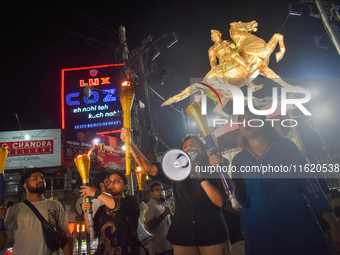 Doctors march with burning torches and shout slogans during a protest against the rape and murder of a PGT woman doctor at Government-run R...