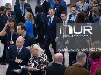 Robert Jenrick MP, the favorite to be the new Tory leader, walks through the ICC surrounded by his security detail at the Conservative Party...