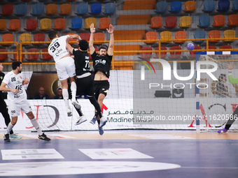 A Veszprem player passes the ball towards the goal during his team's match against Zamalek in the Men's Handball Club World Cup in Cairo. (