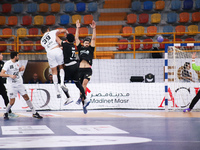 A Veszprem player passes the ball towards the goal during his team's match against Zamalek in the Men's Handball Club World Cup in Cairo. (