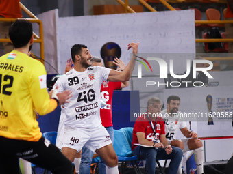 Veszprem player Yehia El-Deraa calls out to his teammate during his team's match against Egypt's Zamalek in the Men's Handball Club World Ch...