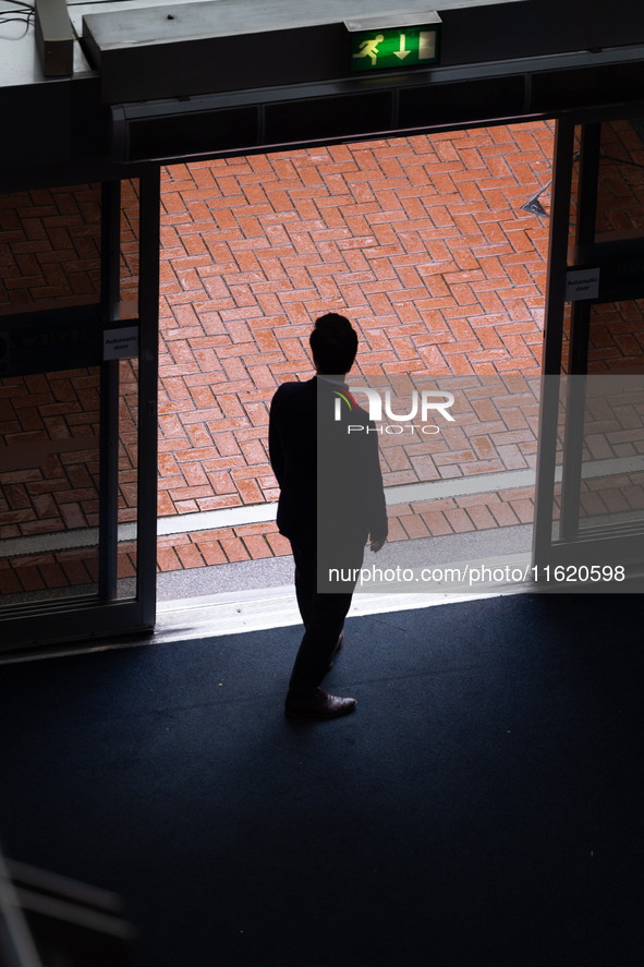 A delegate decides not to go out in the rain at the Conservative Party Conference at the International Conference Centre in Birmingham, Engl...