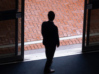 A delegate decides not to go out in the rain at the Conservative Party Conference at the International Conference Centre in Birmingham, Engl...