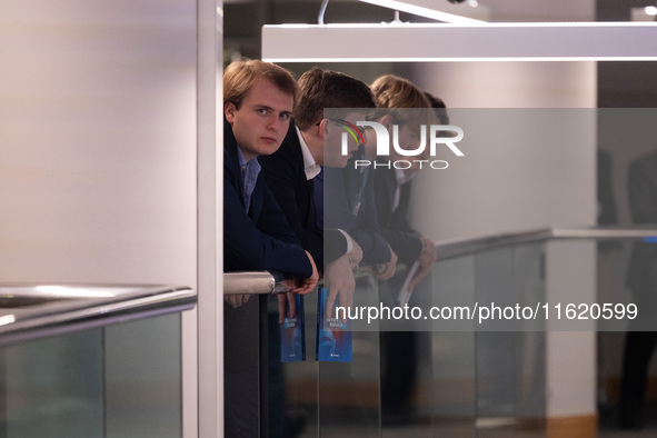 Delegates hang over a balcony at the Conservative Party Conference at the International Conference Centre in Birmingham, United Kingdom, on...