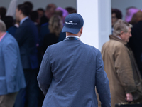 One of Tom Tugendhat's team wears a ''TOM I'M A TUGEND-HAT'' hat backwards at the Conservative Party Conference at the International Confere...