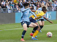 Jorelyn Carabali #16 of Brighton & Hove Albion W.F.C. is challenged by Aoba Fujino #20 of Manchester City W.F.C. during the Barclays FA Wome...